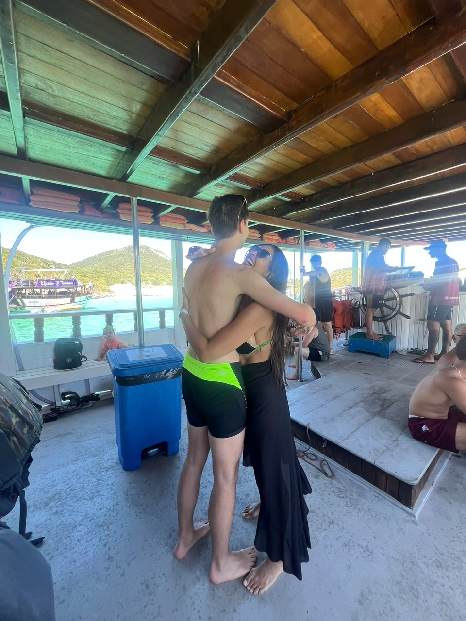 Vanessa dancing with a guest on the deck of a boat