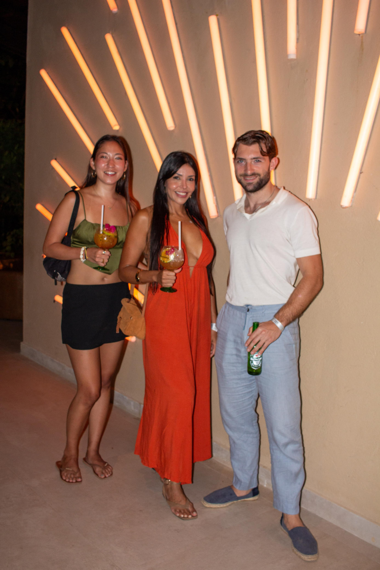 Vanessa and guests with cocktails at a party at night