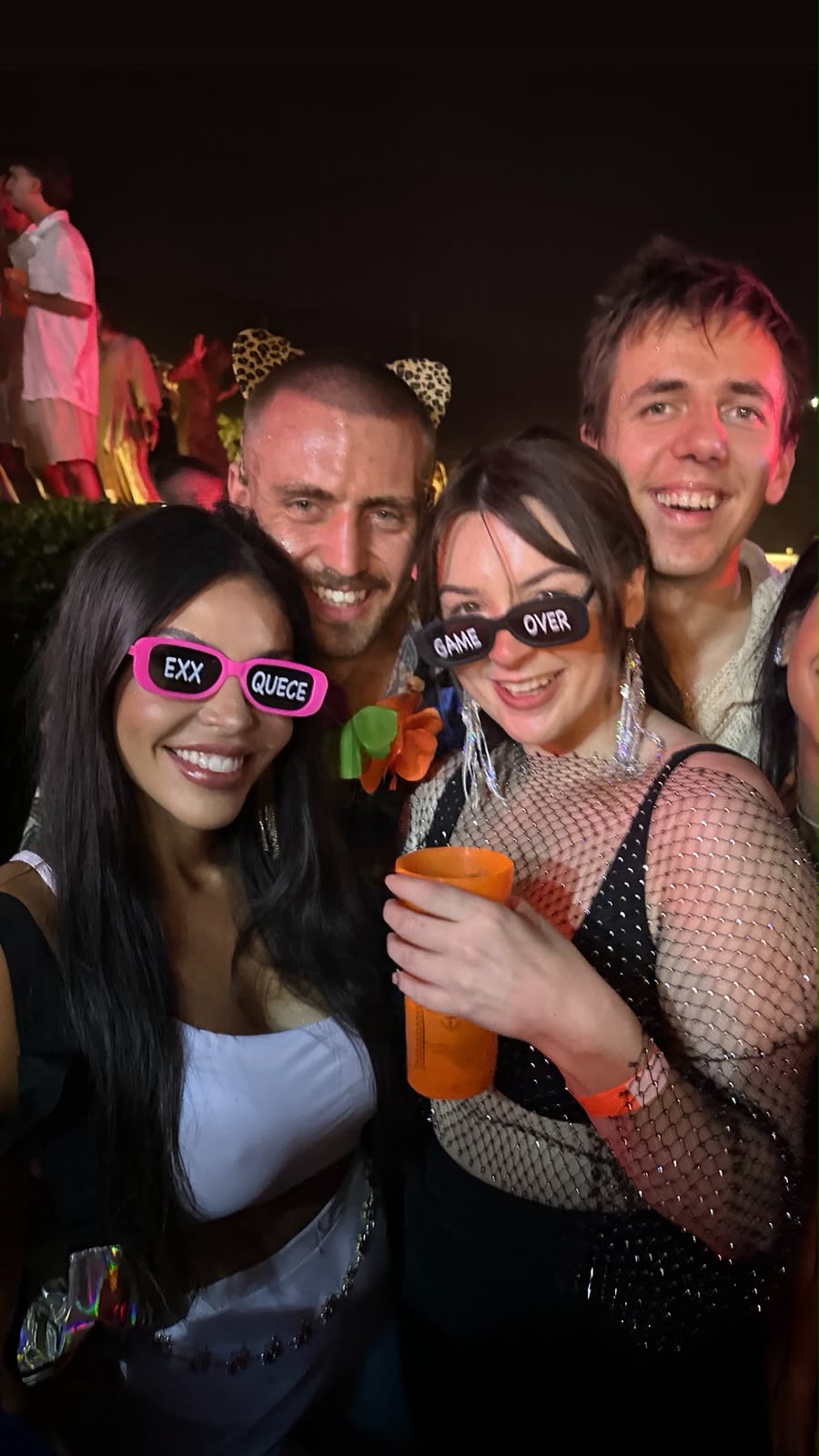 Vanessa and guests smiling together at a Carnival party in Rio at night