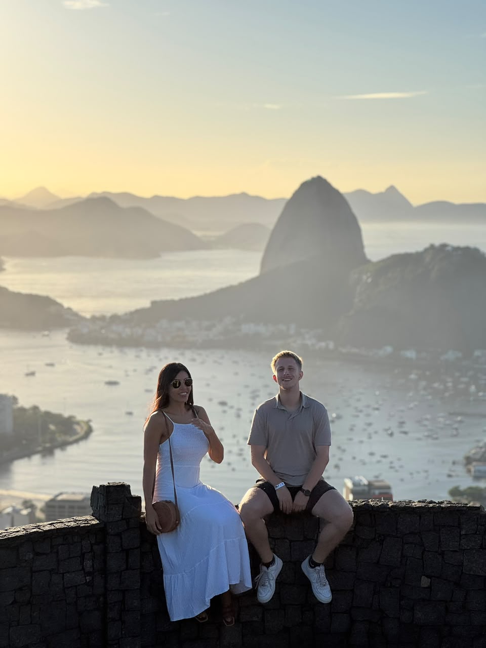 Vanessa and a guest at Mirante Dona Marta at sunset, Sugarloaf in the background