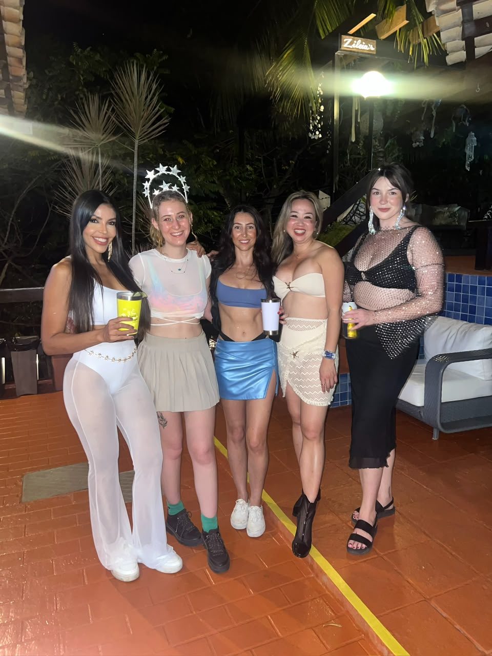 Vanessa and guests all dressed up at a bar at night